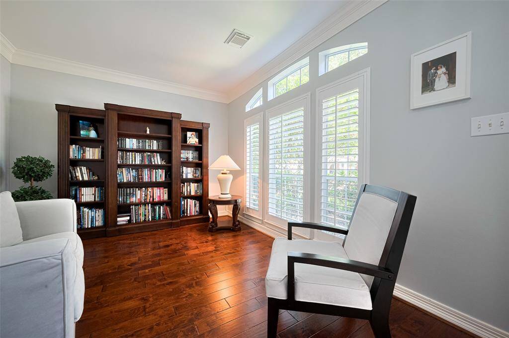Formal living room features wood floors and shutters. An truly elegant space.
