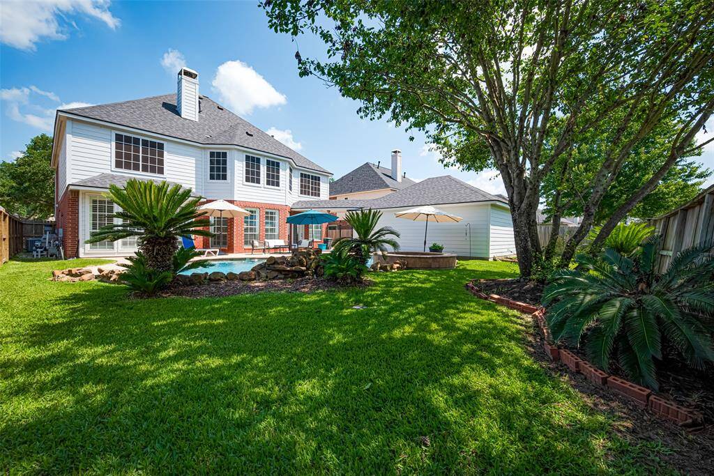The backyard also offers plenty of green space for pets or kids.