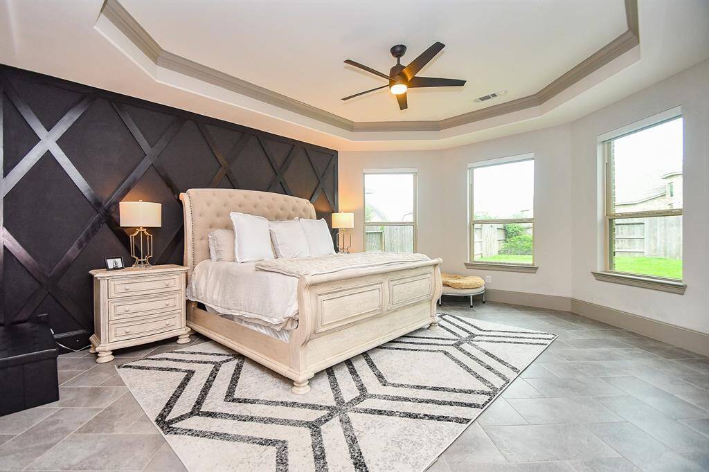 Master bedroom with custom paint, coffered ceiling and bay window!
