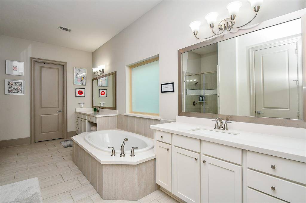 Master bathroom with 2 vanities separate tub and shower!