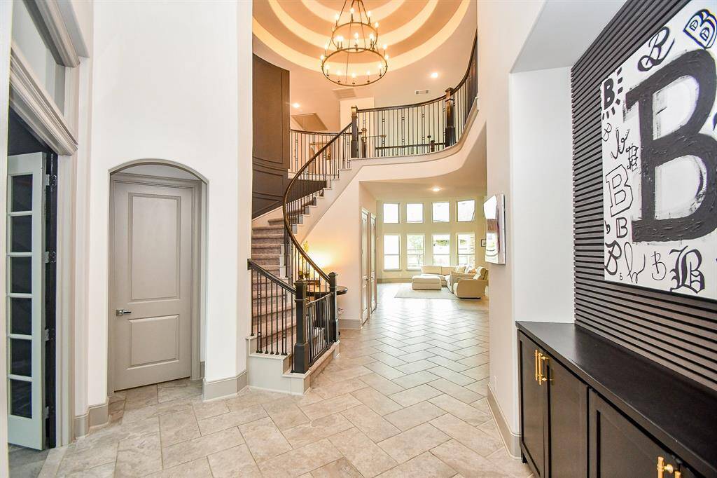 Notice the grand entrance with a built in cabinet and office to the left with french doors!