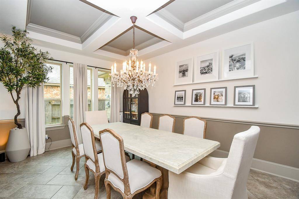 Check out the custom paint, chandelier and ceiling in this huge dining room!