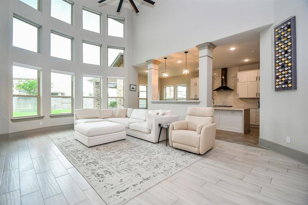 Let the sun shine in! Beautiful living room with windows and automatic blinds!