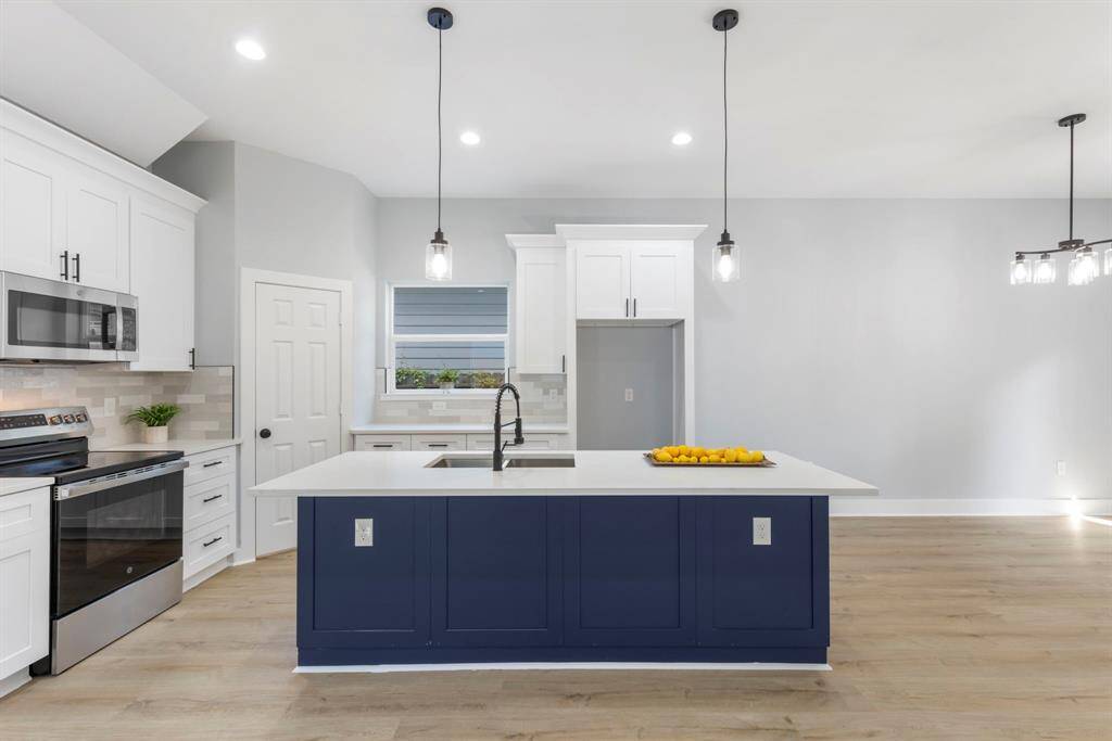 The island offers space for stylish barstools, adding extra seating for family and friends.