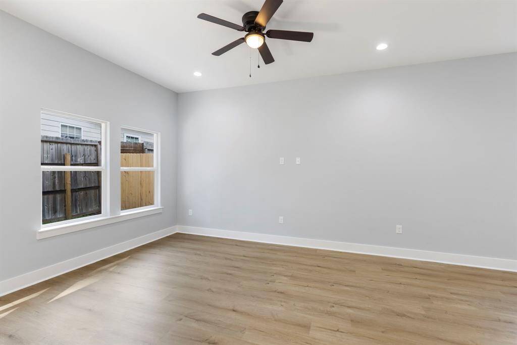 Another angle of the roomy living room that flows right into the dining and kitchen areas, making it easy to stay connected whether you are cooking, relaxing, or entertaining.