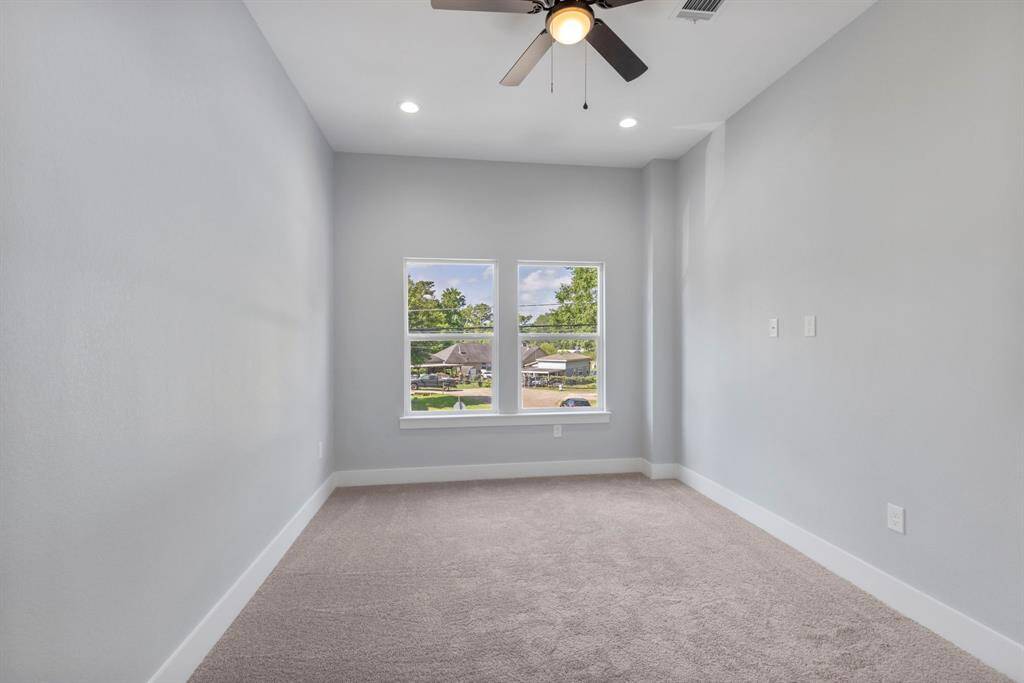 Welcome to the primary suite, featuring large windows, a long layout, and a luxurious bathroom.