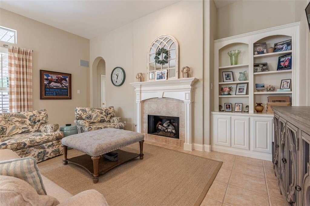 Large family room features a gas log fireplace, built ins, extra storage and has high ceilings!