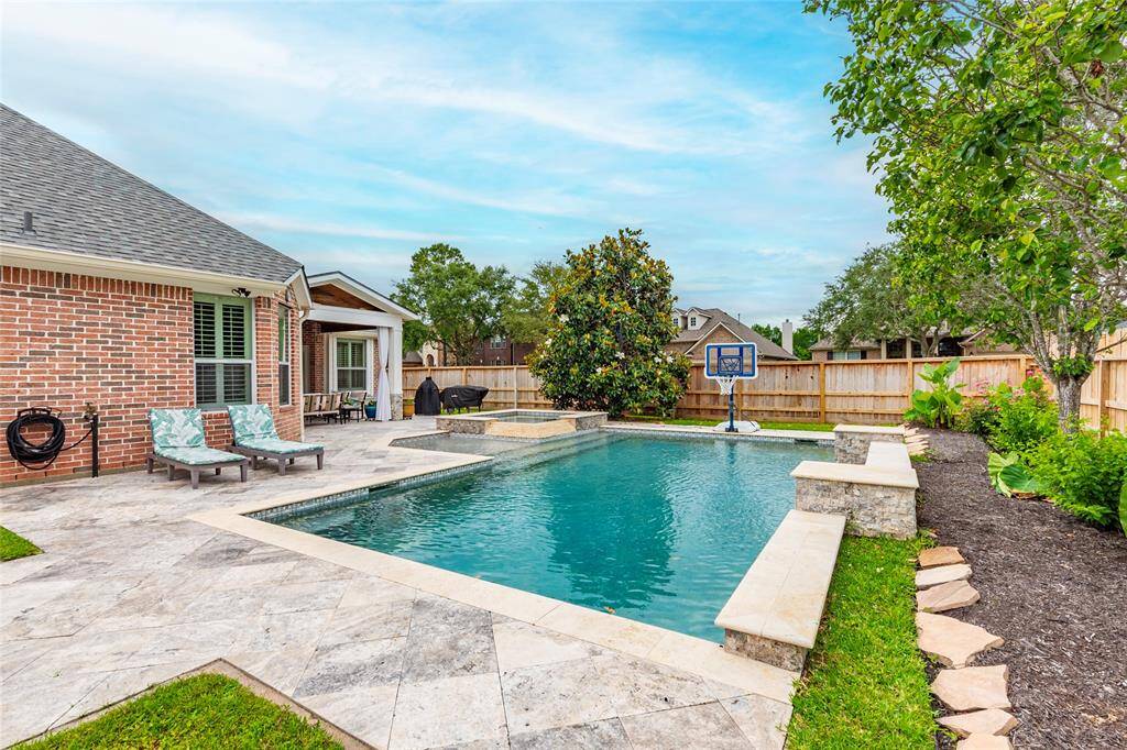 pool is heated and also features a waterfall