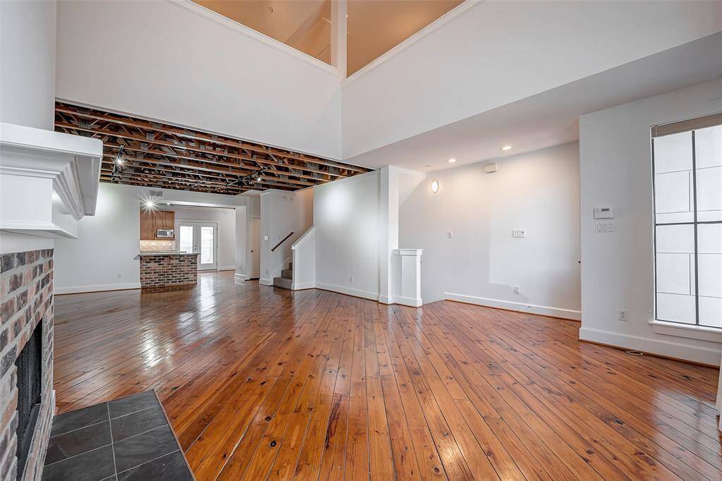 View across the dining area to the kitchen and back doors to patio