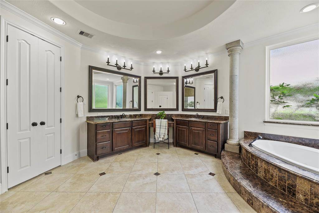 Dual sinks ensure both partners have a dedicated area for grooming and self-care! Ample counter space is only enhanced by the tremendous space beneath, which includes multiple drawers of varying sizes and base storage cabinetry!