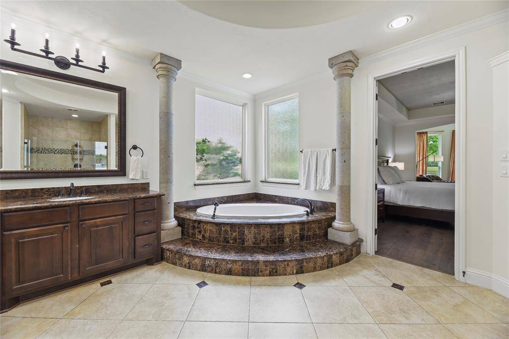 Come home to a glass of wine and a hot aromatherapy bubble bath in your enormous soaking tub. Afterward, easily rinse off the extra bubbles in the separate and spa-like glass enclosed shower.