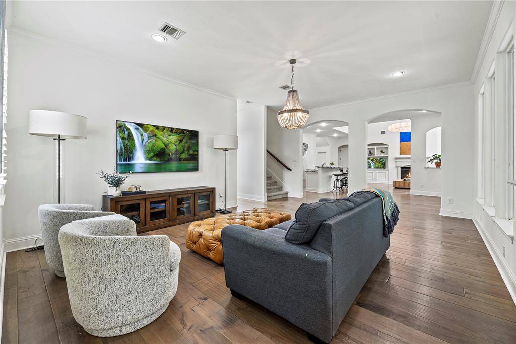 This spacious second living room on the first floor offers a comfortable retreat with plenty of natural light and flexible space for entertaining or relaxing. Its convenient location near the kitchen and main living areas makes it perfect for gatherings or a quiet escape.