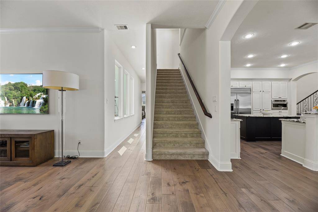 A second staircase leads to the upper level, where you'll find a media room, game room, several bedrooms, and additional bathrooms.