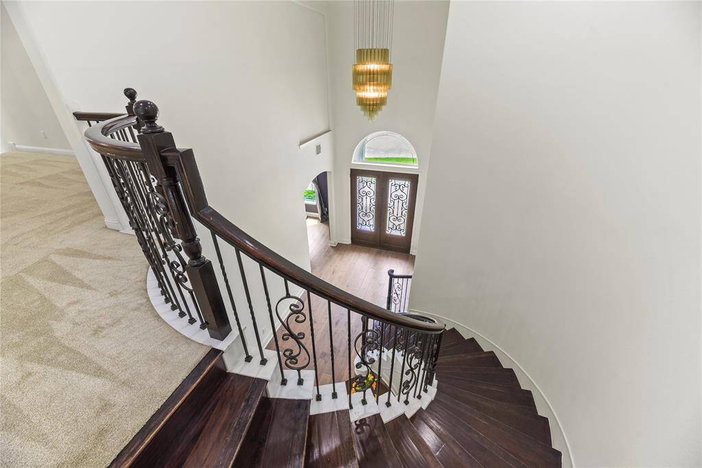 Traditional meets modern with the dazzling staircase. The deep hued banisters wonderfully complement the wrought iron spindles.