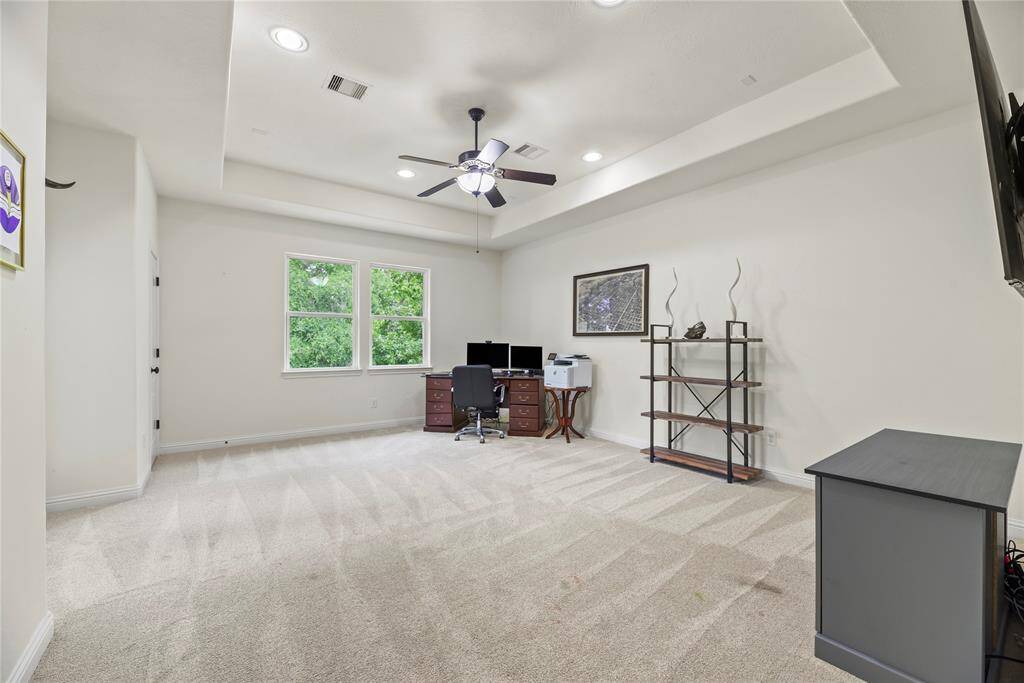 Upstairs, a versatile flex space offers the perfect setup for a second home office, complete with ample natural light and quiet separation from the main living areas. Step through the nearby door to a covered outdoor patio, ideal for work breaks or fresh-air meetings.