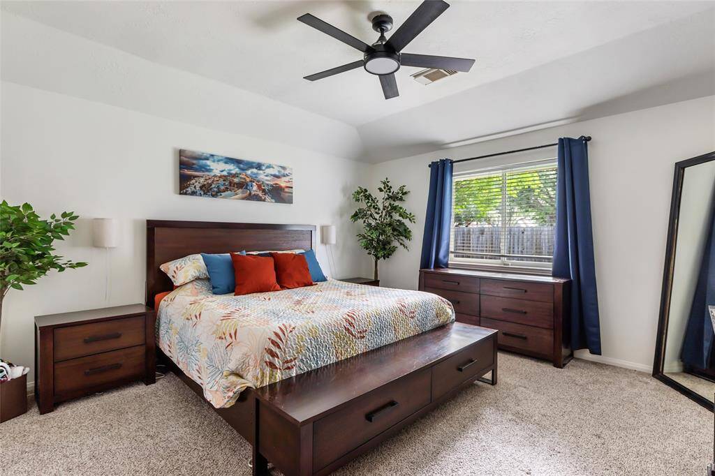 Master bedroom with updated ceiling fan and higher ceiling