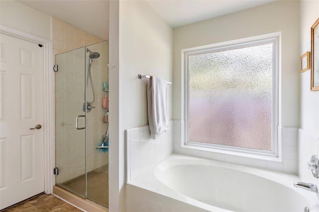 Separate shower and soaking bathtub with updated window