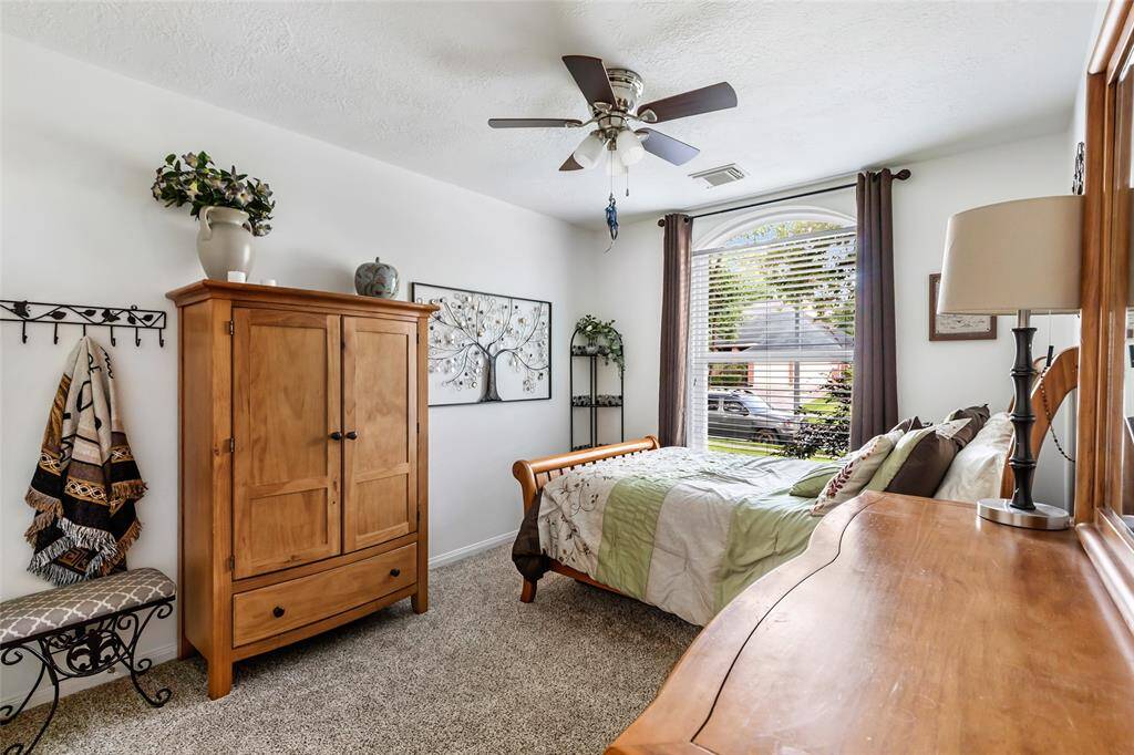 Bedroom 2 with updated ceiling fan and updated window. Curtains and curtain rod excluded.