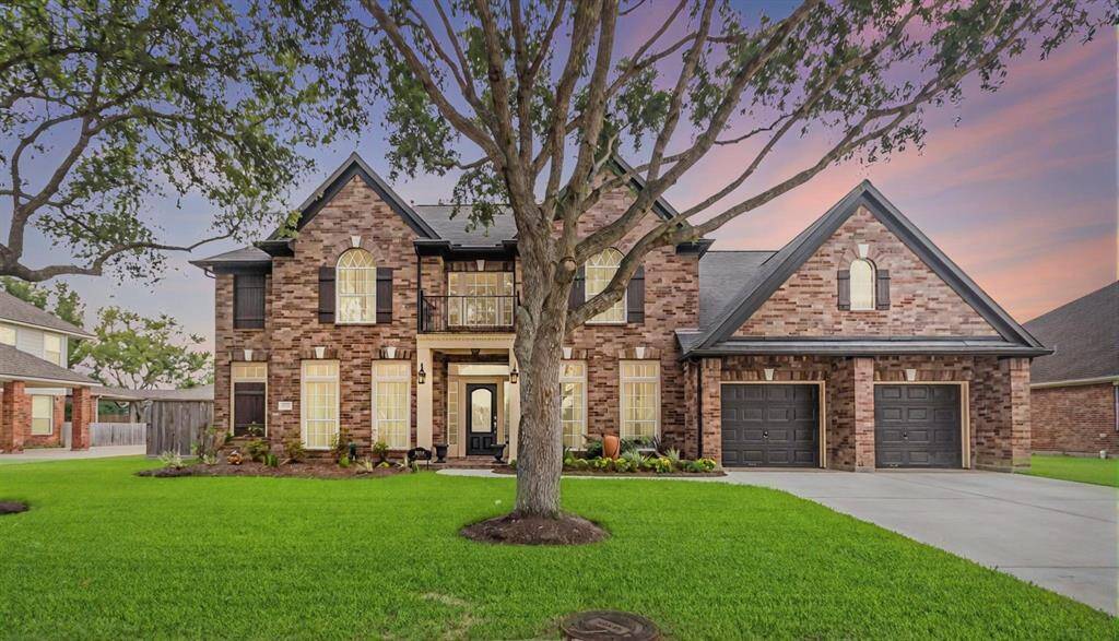 Welcome to this stunning two-story brick home with a large front yard and mature trees. The well-maintained lawn and landscaping enhance its curb appeal.