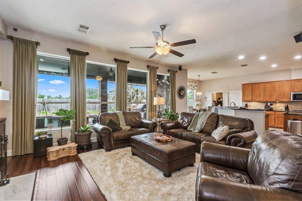 This spacious living flows into an open kitchen with modern appliances, creating a welcoming and functional space ideal for family gatherings or entertaining.