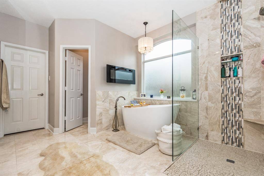 Another view of the electric fireplace that provides relaxing evenings while soaking in your freestanding tub.