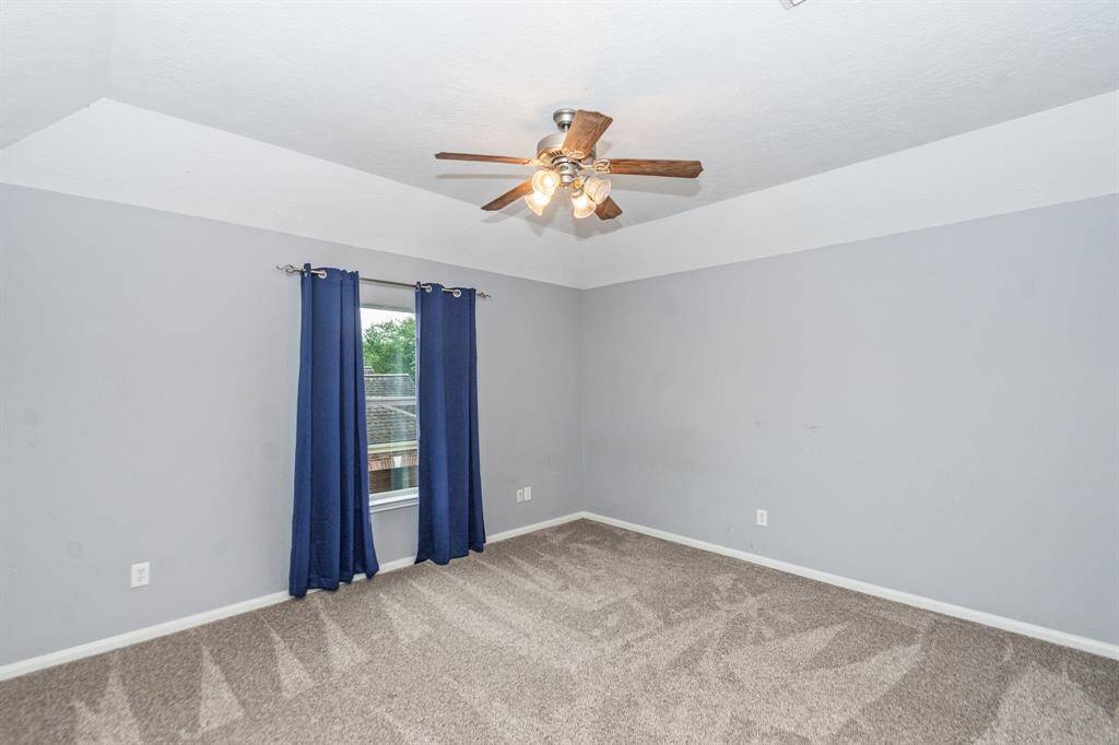 This bathroom features a dual-sink vanity with ample storage, a large mirror with overhead lighting, and a separate toilet area for added privacy.