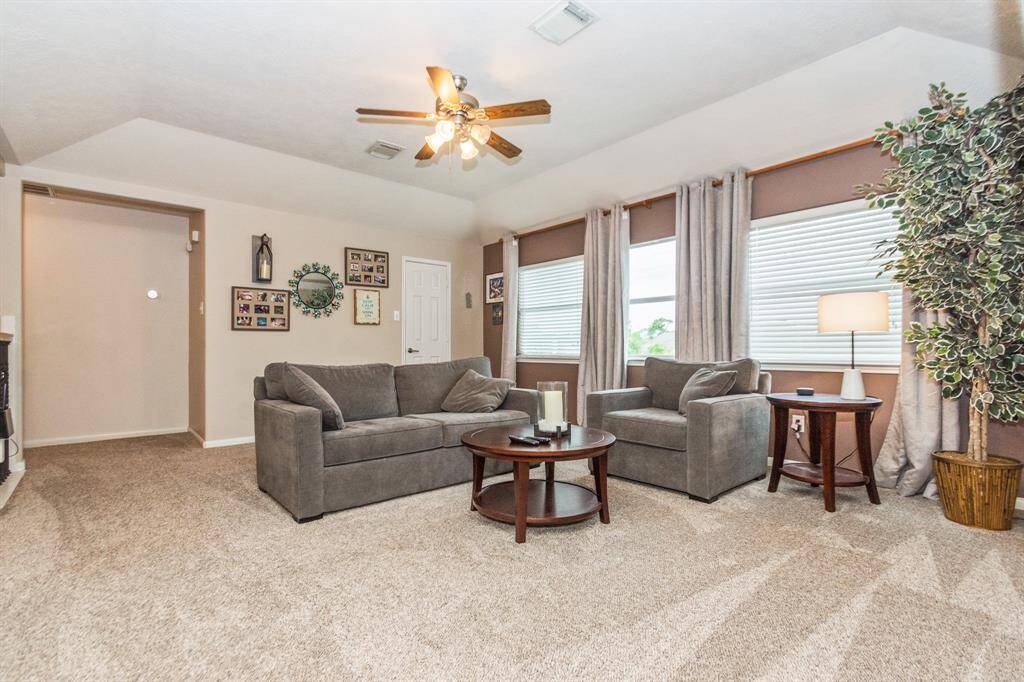 This backyard features a beautifully landscaped pool with natural stone edging, surrounded by a privacy fence. Perfect for relaxation and entertaining!