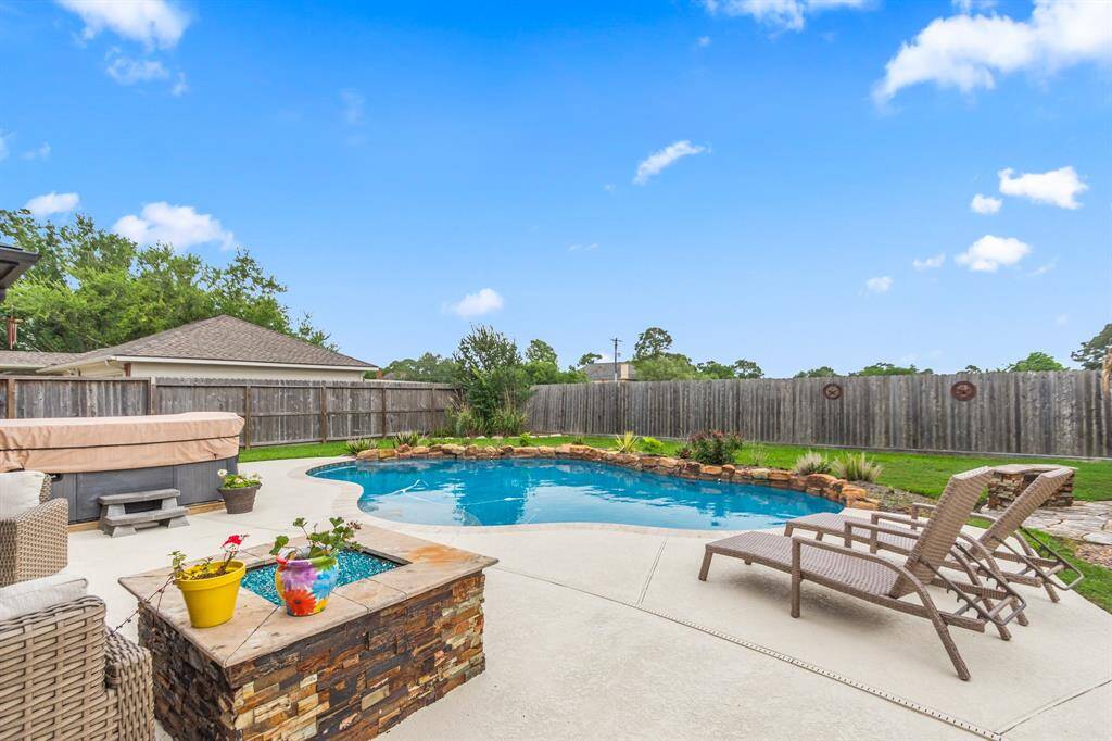 Spacious two-story brick home with a large backyard featuring a pool and patio area. Located in a suburban neighborhood with well-maintained lawns and tree-lined streets