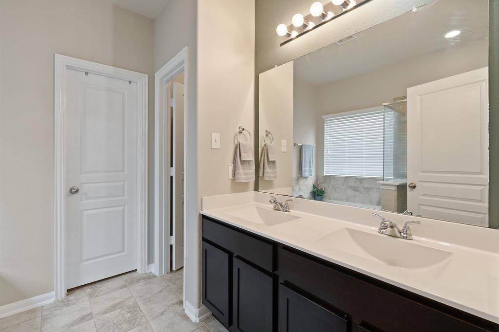 Spacious double vanity with ample storage and bright lighting