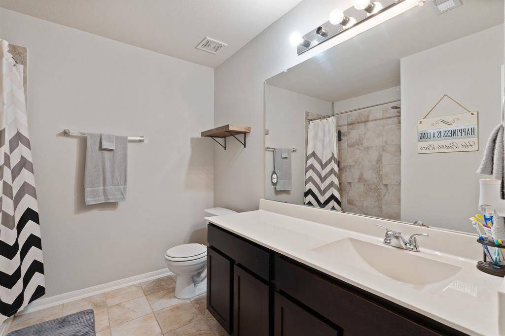 Clean and modern secondary bathroom with ample storage