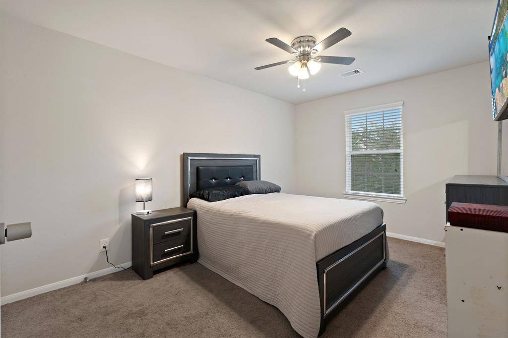 One of three bedrooms upstairs, all large enough to accommodate