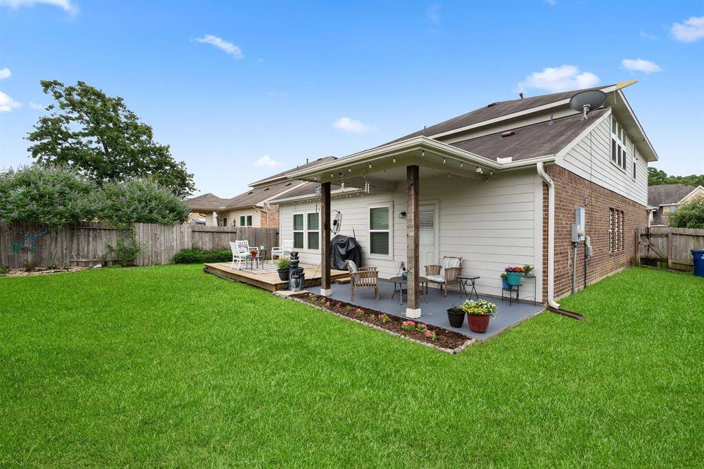 Large fenced yard with covered patio and plenty of potential