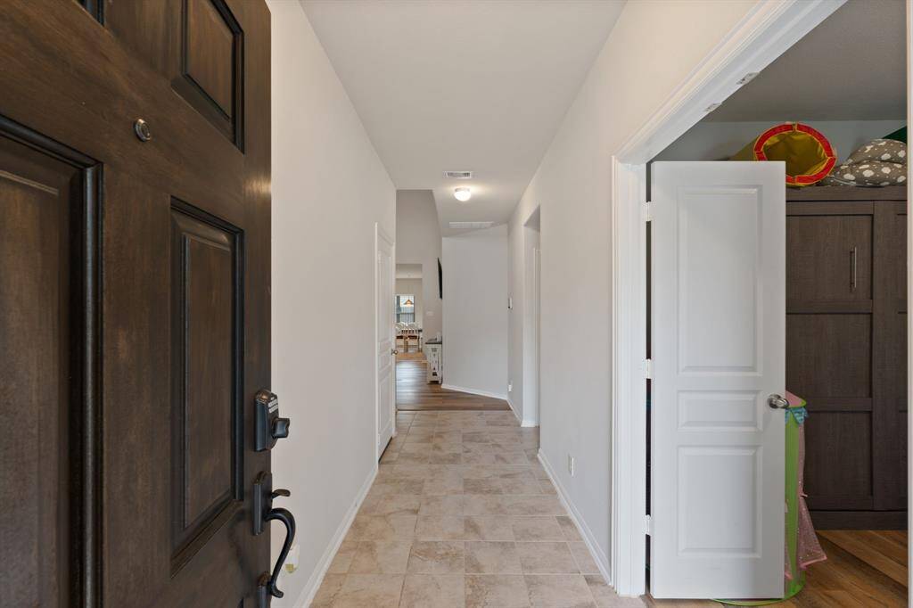 Welcoming entry with durable tile flooring and a clear view to the main living area with office/flex space as you enter to right