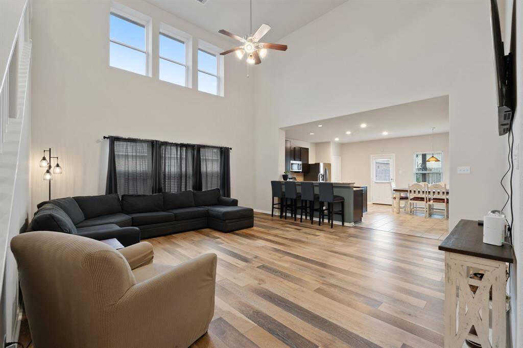 Open concept living with stunning high ceilings and modern flooring.