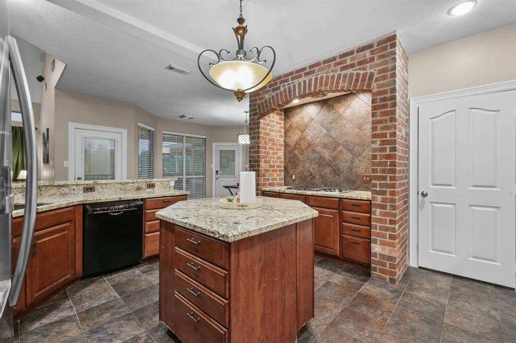4 burner Gas stove is located in a charming brick trimmed setting