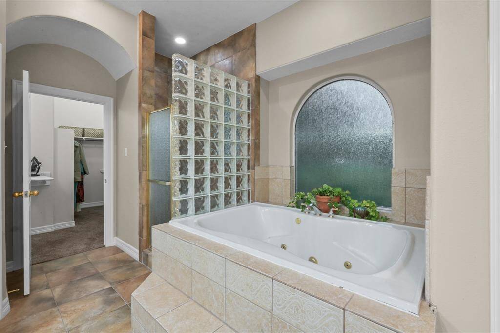 Soaker/jetted tub and rain glass & glass blocks create a relaxing atmosphere.  Also a stand alone shower