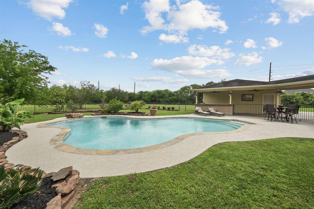 Pool, outdoor kitchen, covered patio area all sets the stage for entertaining!