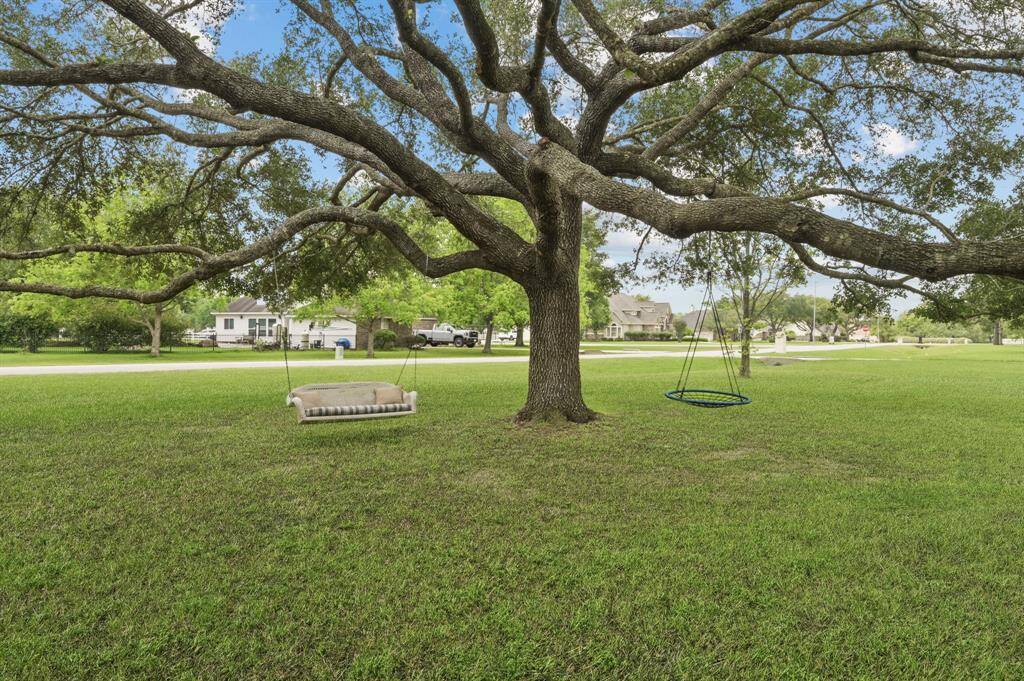 Mature oak trees on the property offer plenty of shade and a place to swing while relaxing on your expansive front lawn