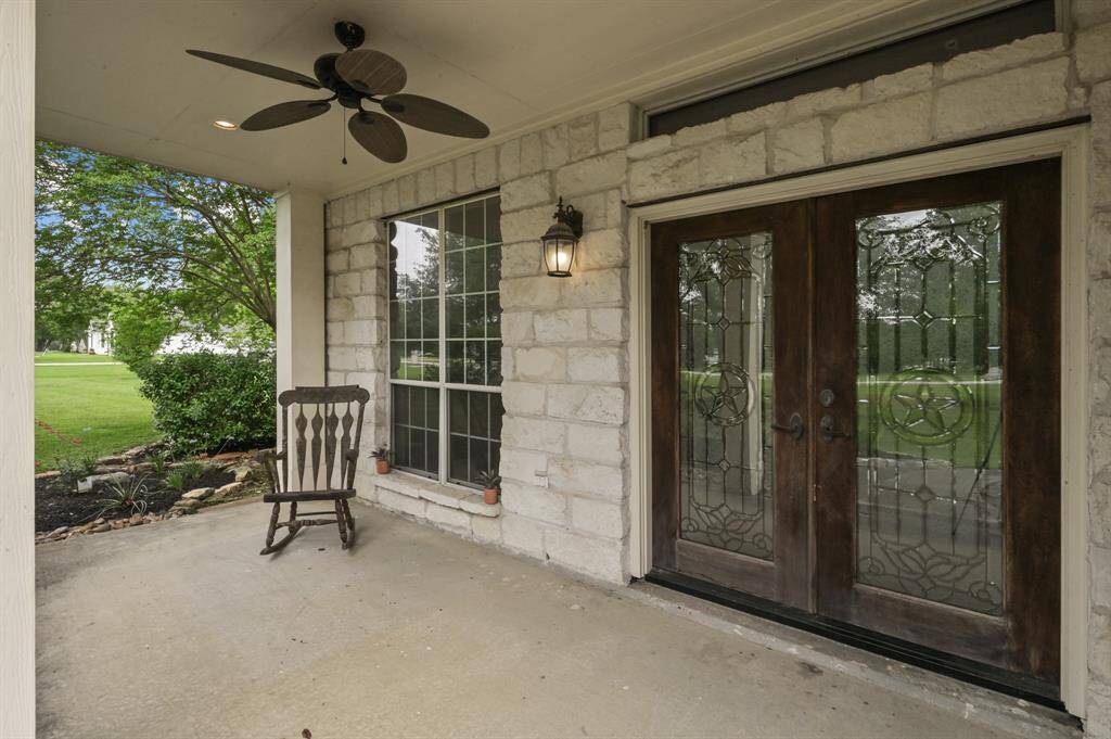 The covered front porch complete with fan and double french doors to welcome you home