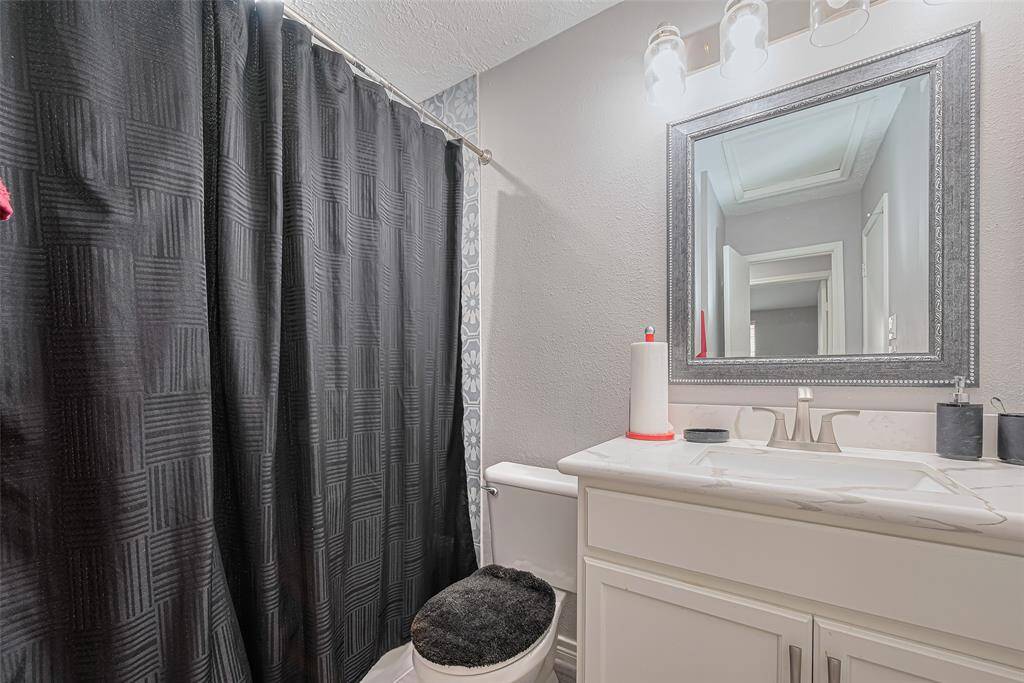 Secondary bath features combo tub/shower, designer tile, quartz counter, undercounter sink, recent fixtures & hardware