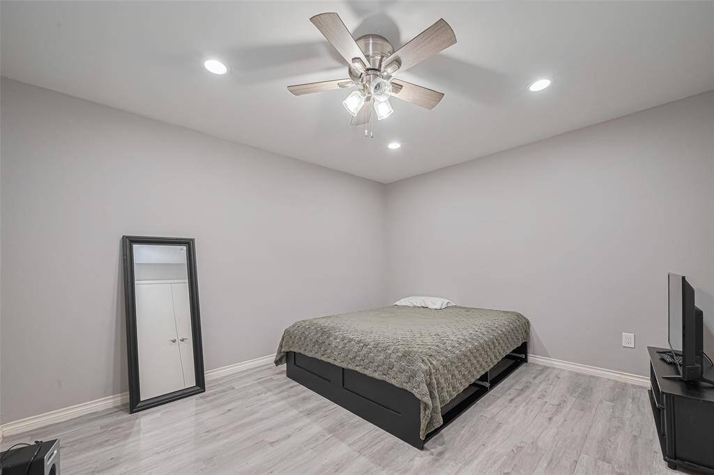 Another view of large flex room.  Decorator paint, recessed lighting, luxury vinyl plank flooring and ceiling fan are notable features.