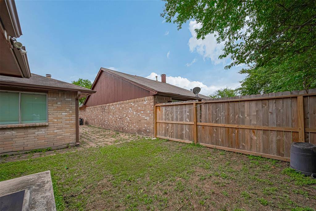 Another view of back and side yards, fence and pavers