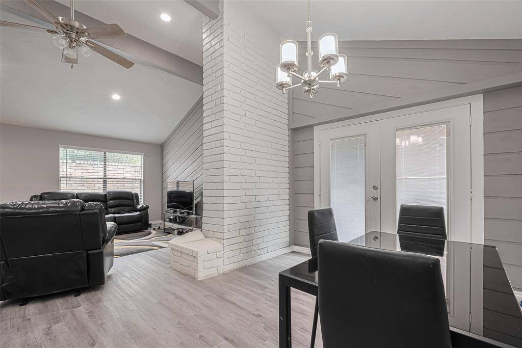 This photo is shot at an angle toward the front & side of the home. This home is an architectural delight. Double store doors lead to patio area and then to backyard.