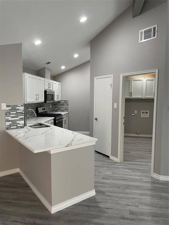 View of kitchen, breakfast bar, utility room and pantry door without furnishings