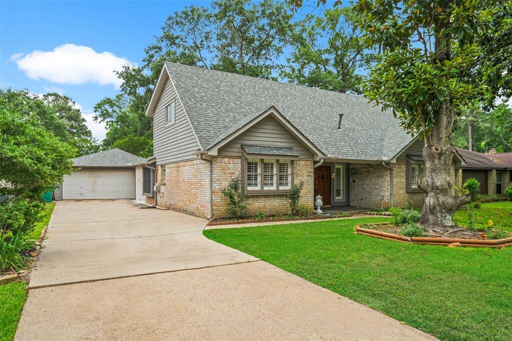 Ample parking in concrete driveway leading to detached garage.