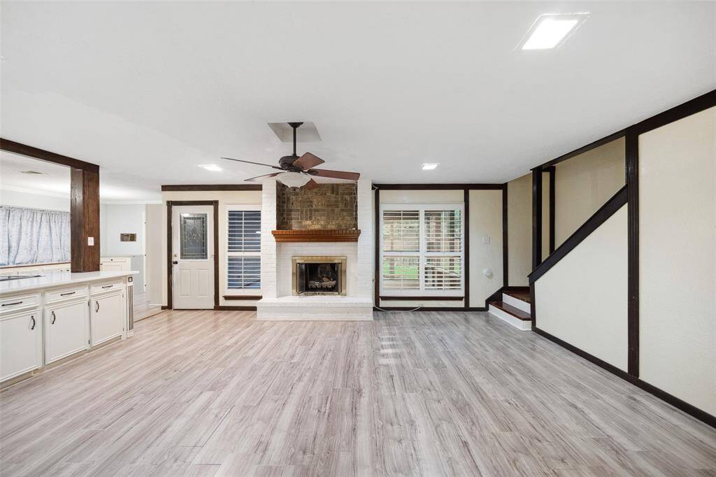Living room with cozy fireplace at entry.