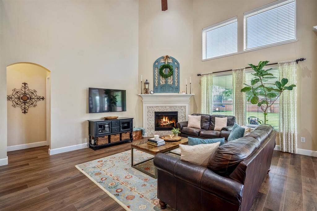 The herringbone tiled formal gas fireplace surround offers the room’s focal point, with beautiful large windows offering views of the backyard.