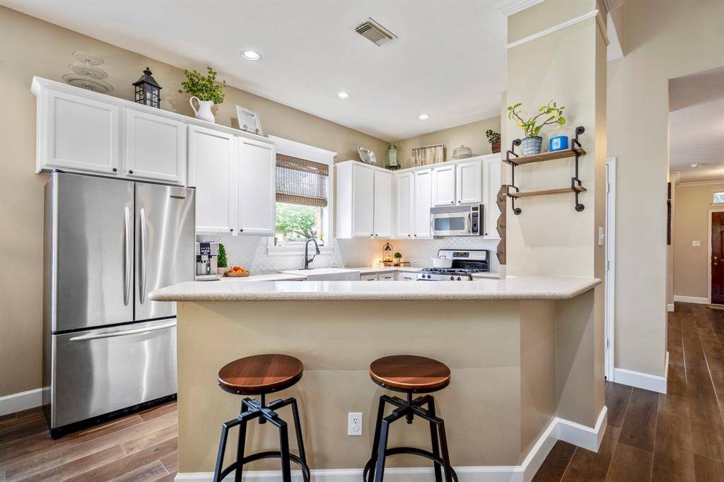 The breakfast bar offers versatility in dining or entertaining.