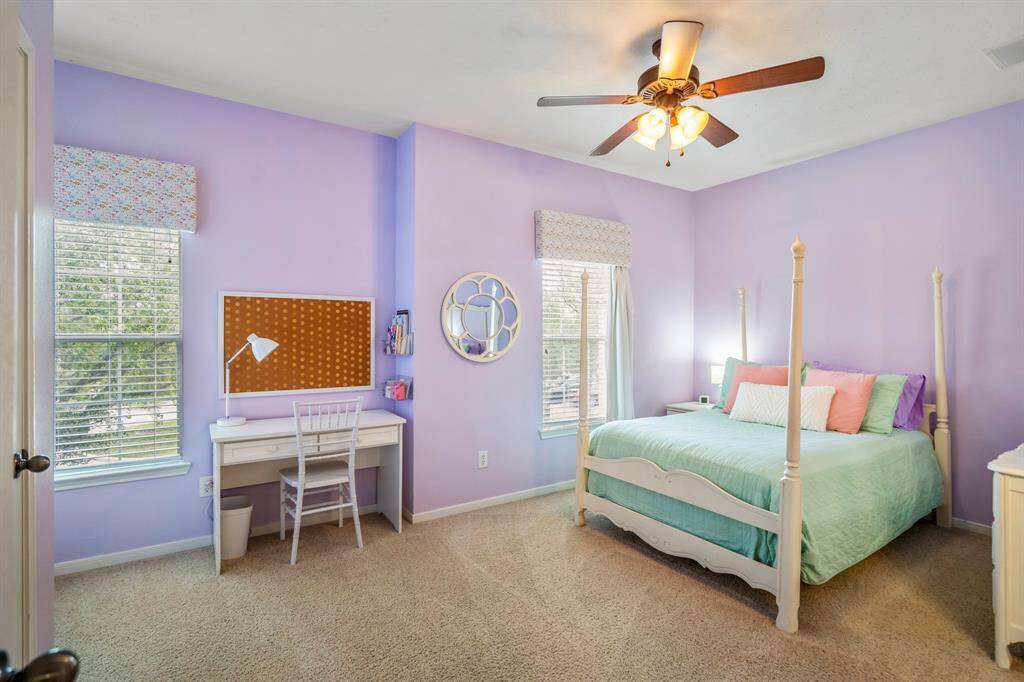 The third bedroom upstairs offers dual windows with beautiful window coverings. Plenty of space of additional desk area or larger furniture.
