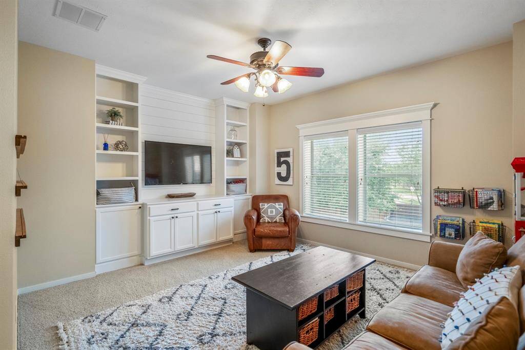 Upstairs you will find this large gameroom with custom built-ins, and large window overlooking the backyard.